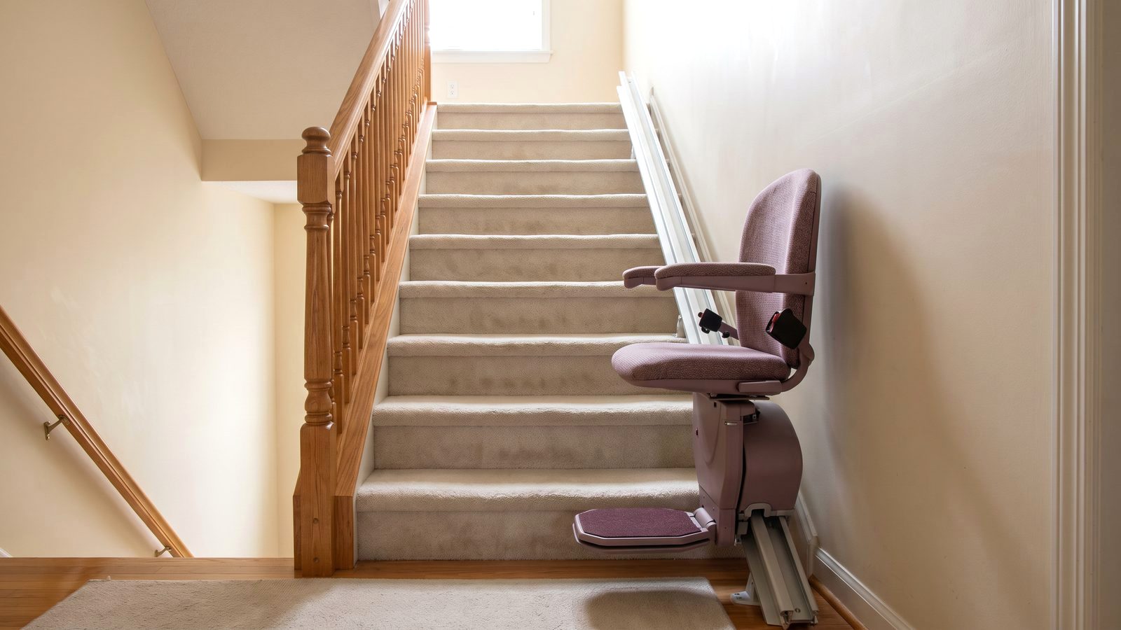 Stair elevator chair on a straight staircase in a family home, the lowest stair elevator cost